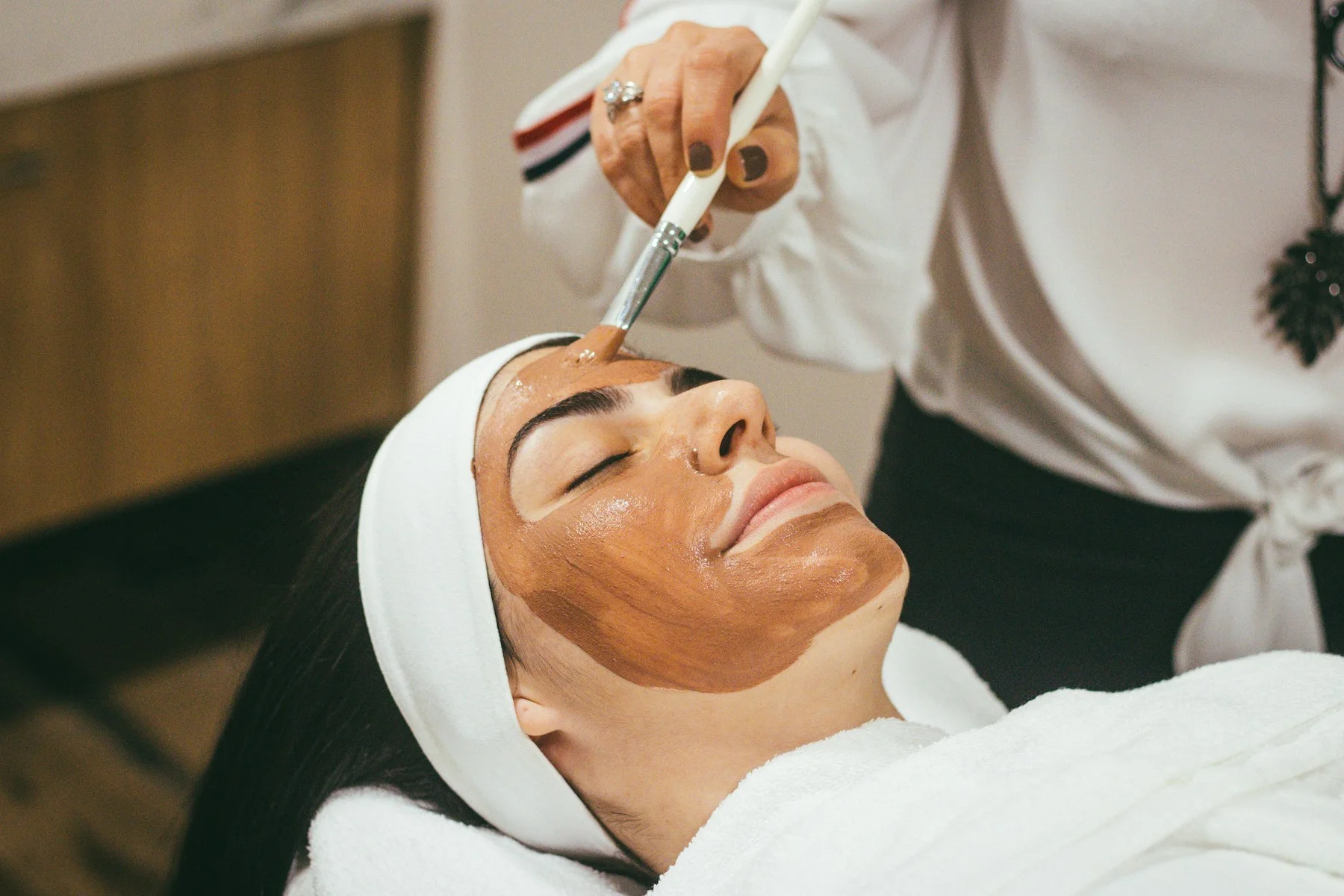 Adult receiving a non-graphic professional facial treatment